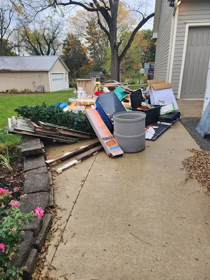 Dumpster being loaded with debris for Estate Cleanout Dumpster Rental in Daphne